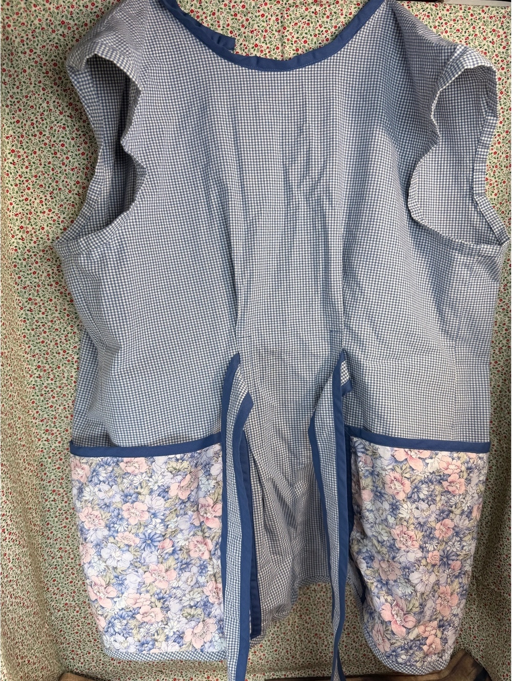 Blue romper apron with floral pockets